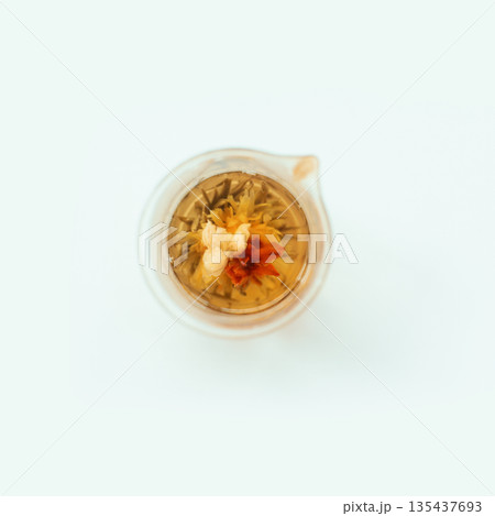 Top view of blooming flower tea in glass teapot on white background Top view of blooming flower tea in glass teapot on white background 135437693