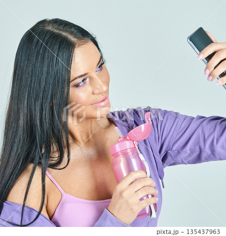 Young caucasian female taking selfie with smartphone, wearing purple outfit Young caucasian female taking selfie with smartphone, wearing purple outfit 135437963