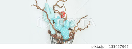 Fabric cactus arrangement with twisted branches in wire basket on light 135437965