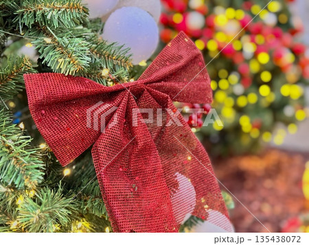 New Year's trees decorated with colorful bright red and white balls, red bows and garlands decorate. 135438072