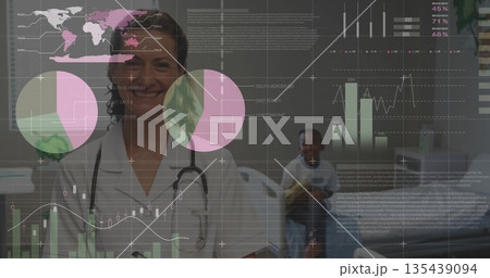Smiling doctor examining child on table in exam room, with stethoscope, yellow ball and data charts Smiling doctor examining child on table in exam room, with stethoscope, yellow ball and data charts 135439094