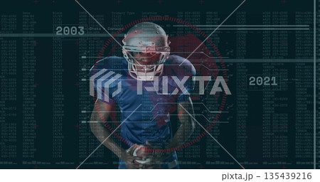 Gripping leather football, football player standing in code arena, with helmet facemask, red target 135439216