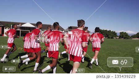 Running jersey teammates sprinting across school field, with cones, hurdles and digital icons 135439229