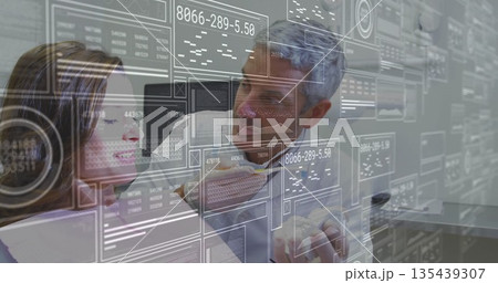 Feeding woman in suit and blouse leaning and tasting sandwich piece in office with holograms Feeding woman in suit and blouse leaning and tasting sandwich piece in office with holograms 135439307