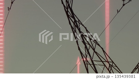 Steel lattice tower towering in corridor, showing power lines and pink bar chart arrow overlay 135439381