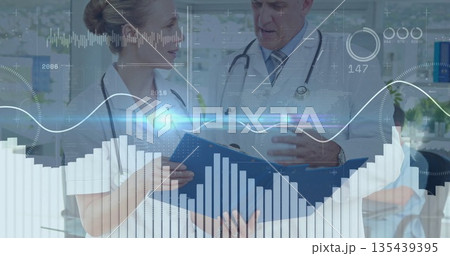 Examining patient files in blue folder at clinic by two doctors with stethoscopes and data overlays Examining patient files in blue folder at clinic by two doctors with stethoscopes and data overlays 135439395