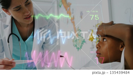 Examining doctor checking boy patient at pediatric clinic, with thermometer and holographic vitals Examining doctor checking boy patient at pediatric clinic, with thermometer and holographic vitals 135439484