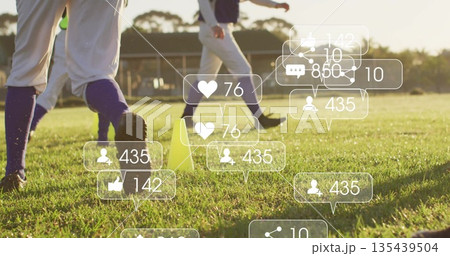 Practicing athletes in white trousers drilling footwork on grass with yellow cones social overlays 135439504