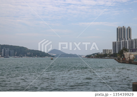 Dec 31 2025 Sai Wan Ho waterfront skyline with coastal residential architecture 135439929
