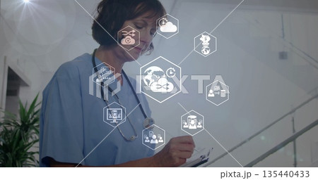 Nurse in scrubs recording in clinic hall with clipboard pen stethoscope floating icons, copy space Nurse in scrubs recording in clinic hall with clipboard pen stethoscope floating icons, copy space 135440433