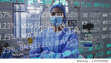 Standing surgeon in scrubs in OR, with surgical instruments, overlay showing codes and percentages 135440466