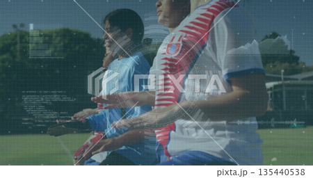 Moving six soccer players coordinating on green grass training ground, with gloves and cones Moving six soccer players coordinating on green grass training ground, with gloves and cones 135440538