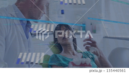 Leaning white coat dentist explaining procedure in dental clinic, with chair, lamp and data overlay 135440561
