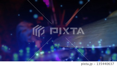 Striking metallic cymbal with drumsticks, drummer performing on stage with stage lights, copy space Striking metallic cymbal with drumsticks, drummer performing on stage with stage lights, copy space 135440637