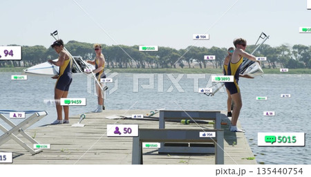 Lifting shell and adjusting oars, rowers wearing yellow navy uniforms training on dock near bench 135440754