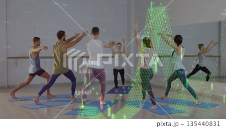Six adults performing yoga in fitness studio, with blue mats, mirrored barre and green data graphs 135440831