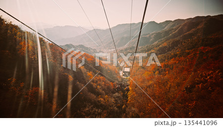 Aerial View of Cable Cars Over Autumnal Mountain Range 135441096