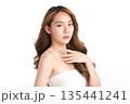 A beautiful young Asian woman with clean, fresh skin against a white background. Skincare, facial treatment, cosmetology, beauty, and spa. An elegant portrait of an Asian woman. 135441241