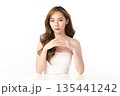 A beautiful young Asian woman with clean, fresh skin against a white background. Skincare, facial treatment, cosmetology, beauty, and spa. An elegant portrait of an Asian woman. 135441242
