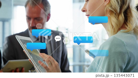 Woman in cardigan tapping smartphone at office, with tablets, floating chat bubbles, copy space Woman in cardigan tapping smartphone at office, with tablets, floating chat bubbles, copy space 135443071