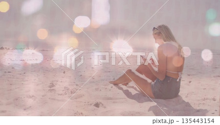 Sitting woman scrolling smartphone on sandy beach at midday with sunglasses and flare, copy space Sitting woman scrolling smartphone on sandy beach at midday with sunglasses and flare, copy space 135443154