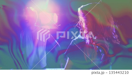 Performing female singer holding microphone near keyboard on stage, with swirling haze, copy space 135443210