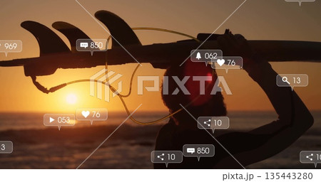 Walking surfer in wetsuit carrying surfboard on sunset beach, with leash, social icons, copy space Walking surfer in wetsuit carrying surfboard on sunset beach, with leash, social icons, copy space 135443280