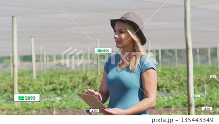 Holding tablet, farm manager recording crop data under shade netting, copy space Holding tablet, farm manager recording crop data under shade netting, copy space 135443349