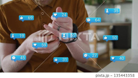 Man in mustard polo sitting at dining table, adjusting black smartwatch with floating media icons 135443358