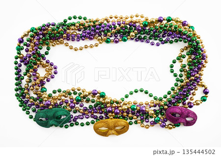 Mardi gras party beads creating frame with masks Mardi gras party beads creating frame with masks 135444502