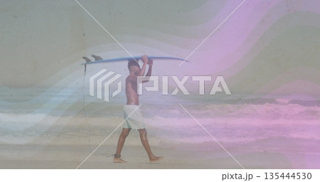 Walking shirtless surfer carrying surfboard overhead at beach with ankle leash and swim trunks Walking shirtless surfer carrying surfboard overhead at beach with ankle leash and swim trunks 135444530