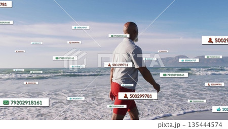 Strolling man wearing white polo shirt and red shorts along beach, with floating data labels Strolling man wearing white polo shirt and red shorts along beach, with floating data labels 135444574