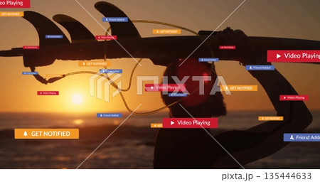 Walking shirtless man carrying longboard toward sunset ocean waves, with floating UI notifications 135444633