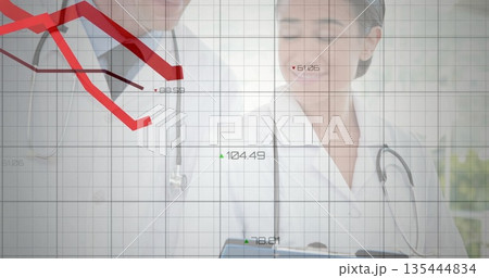 Analyzing doctors reviewing metrics on digital tablet in clinic, with stethoscopes and grid overlay 135444834