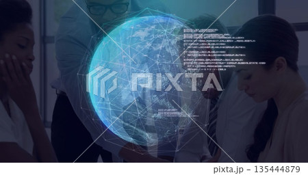 Studying network data business team leaning over conference table in office with holographic globe 135444879