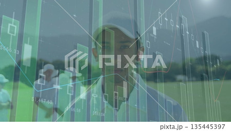 Standing golfer wearing light cap and polo shirt on fairway, showing financial data overlays 135445397