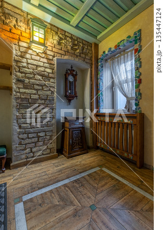 Rustic hallway detail with antique clock and mosaic window Rustic hallway detail with antique clock and mosaic window 135447124