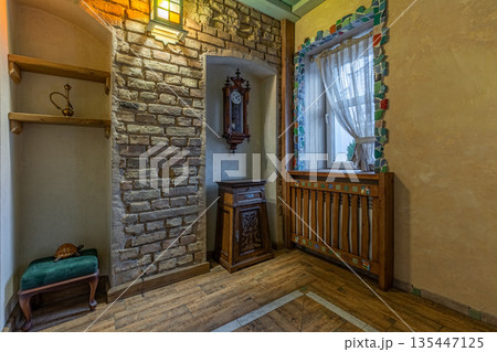Rustic hallway interior with brick niche and mosaic window decor 135447125