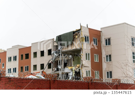 Building damaged in construction accident at urban site in early morning hours 135447615