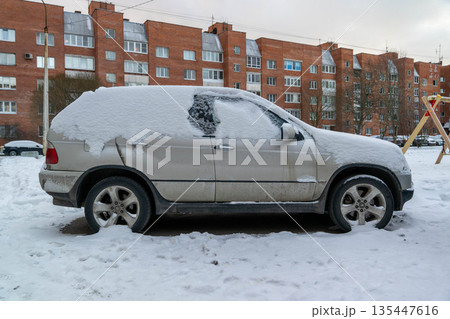 Snow covers parked car in residential area during winter season Snow covers parked car in residential area during winter season 135447616