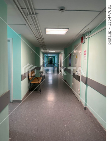 Long hallway in a hospital with chairs and doors on both sides Long hallway in a hospital with chairs and doors on both sides 135447681
