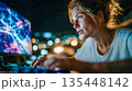 Young woman intensely working at a computer with abstract neural network visuals on screen, representing artificial intelligence, data science, and innovation 135448142