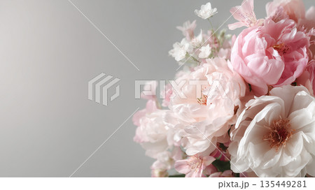 Flowers arranged in a bouquet with soft colors on display against a light background Flowers arranged in a bouquet with soft colors on display against a light background 135449281