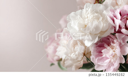 Peonies in soft colors arranged together on a light background during daytime 135449282