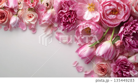 Flower arrangement with pink peonies, tulips, and roses on a light background in springtime setting indoors 135449283