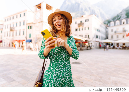 Portrait of smiling woman eating pasta at cozy italian restaurant outdoors. Tourism, food and drink Portrait of smiling woman eating pasta at cozy italian restaurant outdoors. Tourism, food and drink 135449899
