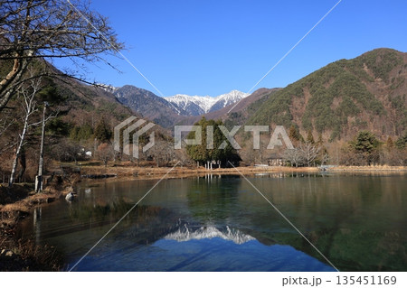 雪をまとった中央アルプスを望む12月の長野県駒ヶ根市 駒が池の冬景色 135451169