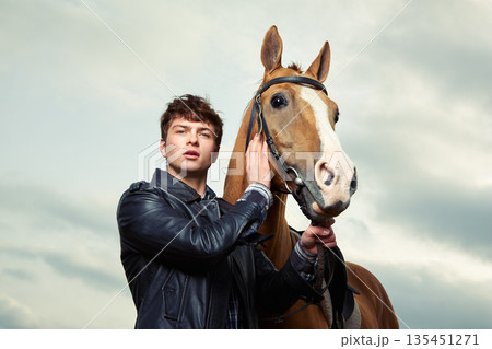 A man hugs a horse outdoors 135451271