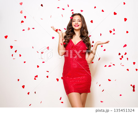 Woman in festive dress under confetti 135451324