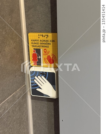 Door sensor panel with hand symbol and warning sign for an automated entry system 135451414